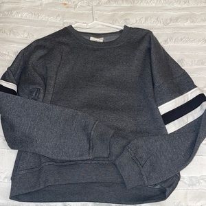grey sweatshirt with black and white striped sleeves